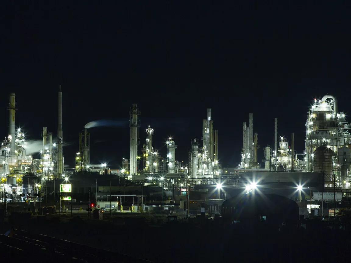 An industrial plant illuminated at night