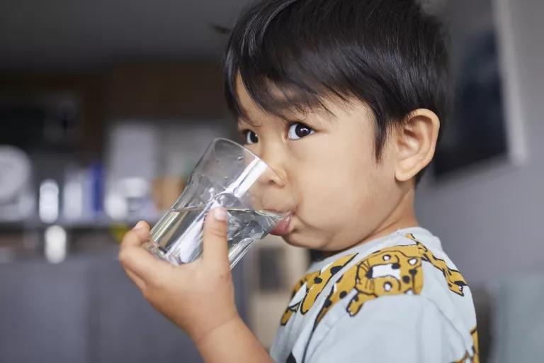 A child drinking a glass of water