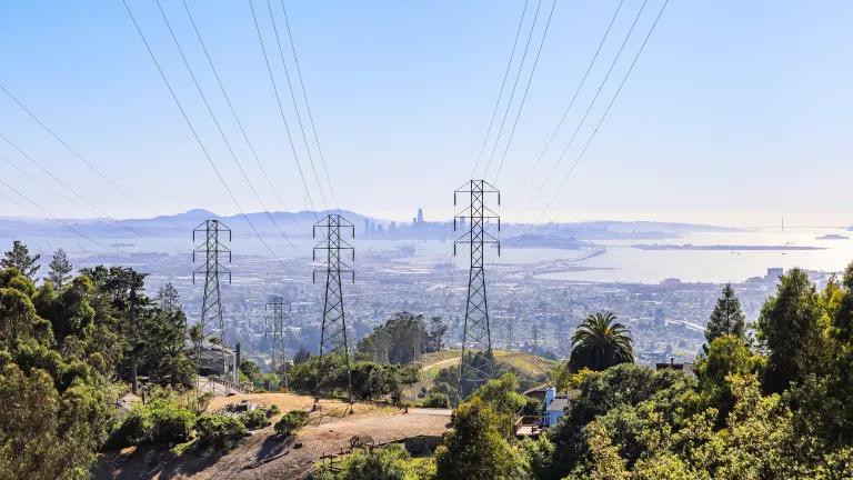 High voltage power lines and pylons on a hilltop overlooking San Francisco, California