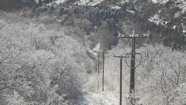 A dusting of snow covers power lines