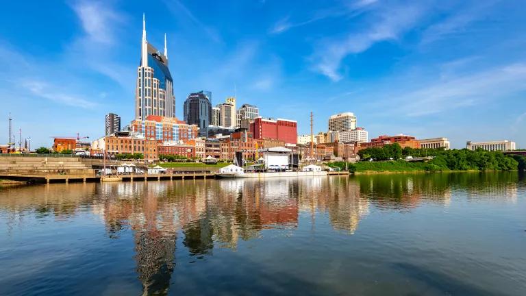 The skyline of downtown Nashville, Tennessee, reflected in the Cumberland River.