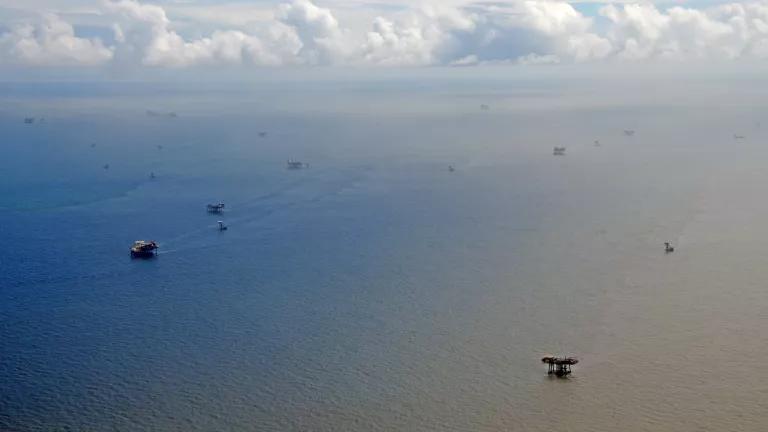 Oil facilities dot a vast expanse of ocean