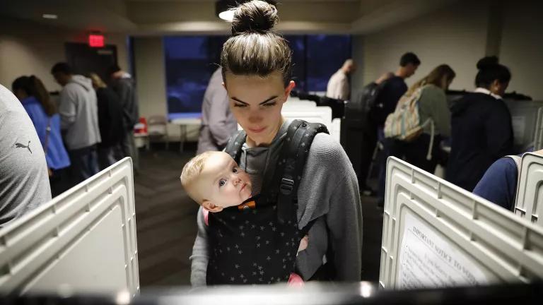 A woman voting with her six-month-old daughter, Nora, on Election Day 2018 in Atlanta