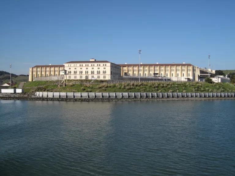 Wide shot of prison buildings taken from across a bay