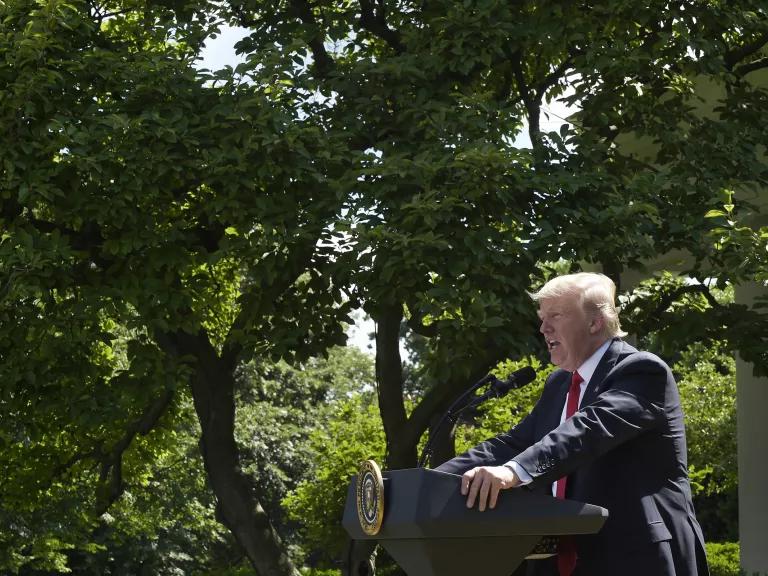 Former U.S. president Donald Trump speaks at a lectern outdoors.