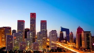 Buildings in the central business district of Beijing, China, lit up at sunset