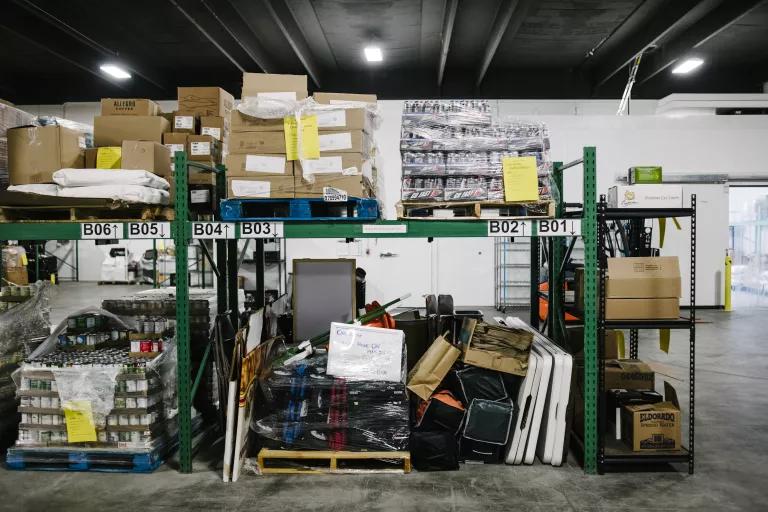 Boxes and bags on shelves in a warehouse 
