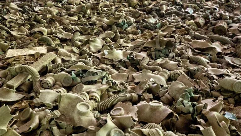 A vast pile of dusty beige gas masks