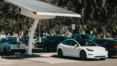 A Tesla being charged by an EV charger