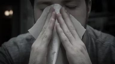 Man blowing his nose